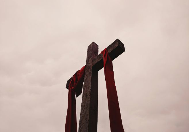 Cross with red cloth draped over it